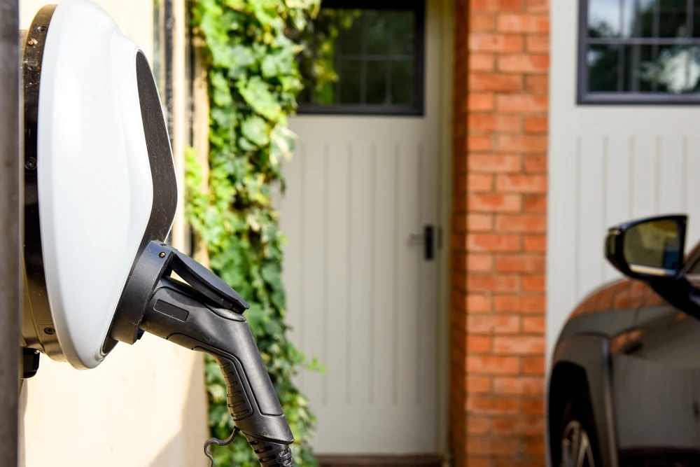 electric-car-plugged-charge-outside-home