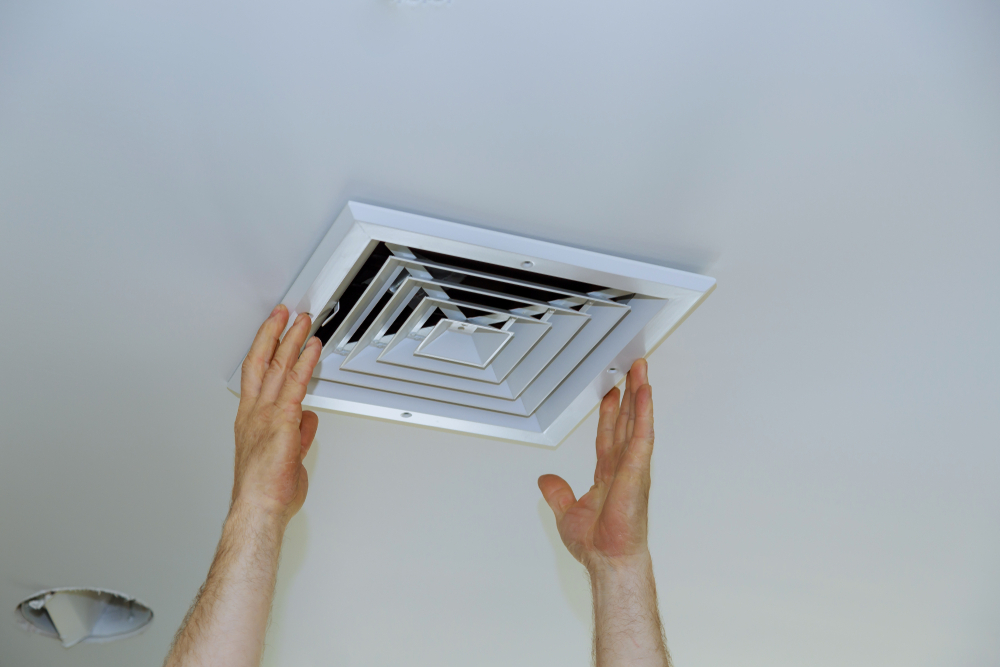 close-man-hand-installing-vent-cover