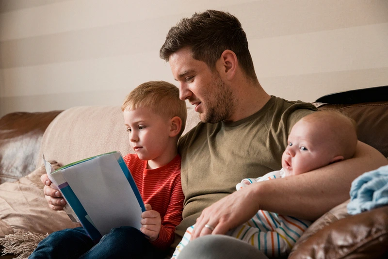 midadult-father-holding-his-newborn-baby