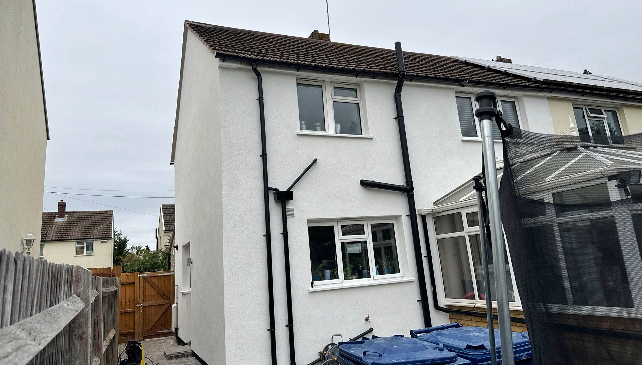 Rear view of a semi-detached house with white exterior walls