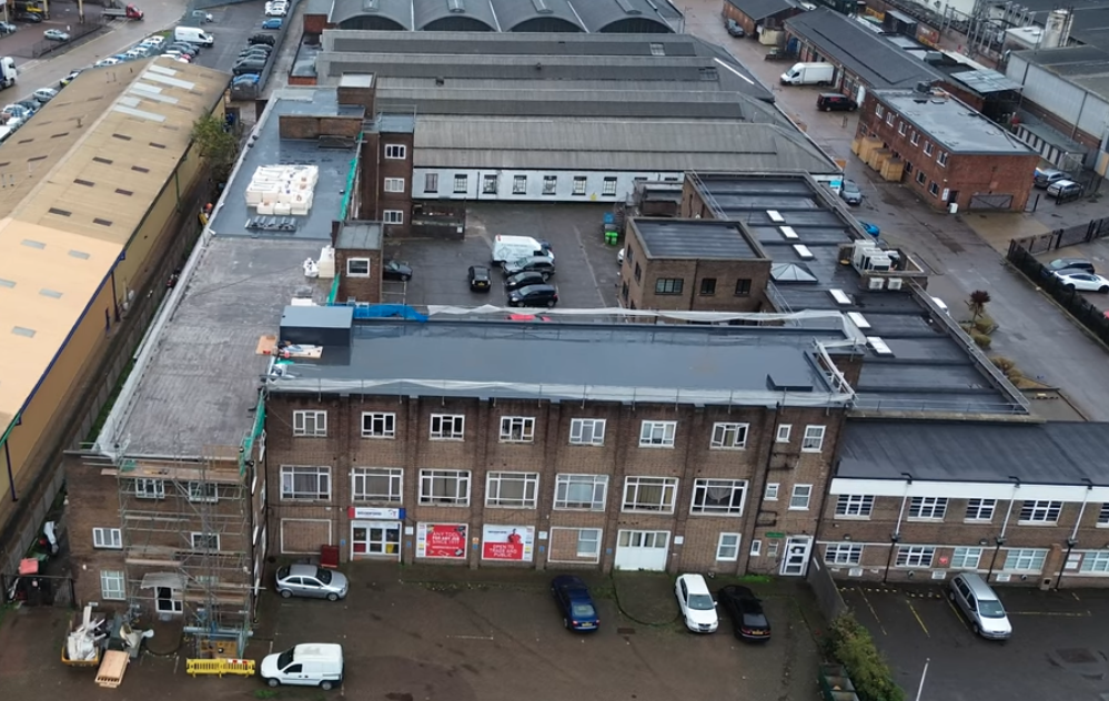 Aerial view of industrial building with completed flat roof installation