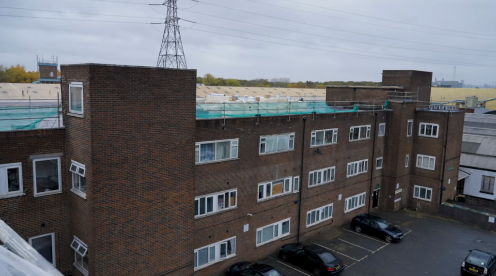 Apartment block with scaffolding and flat roof refurbishment works