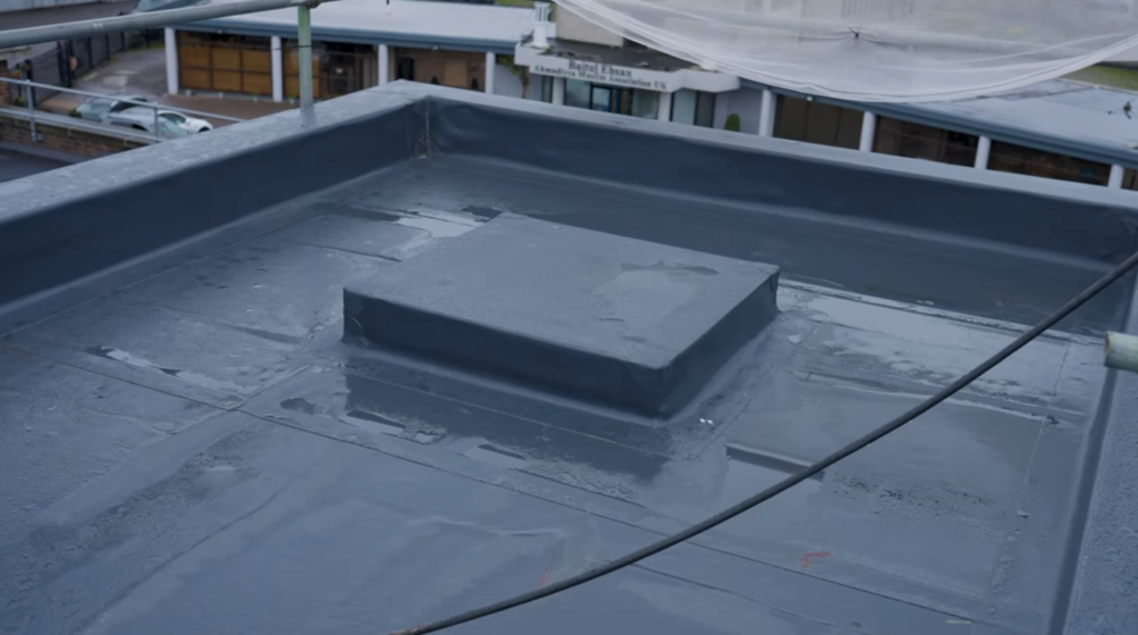 Flat roof detail with waterproof membrane and boxed roof upstand