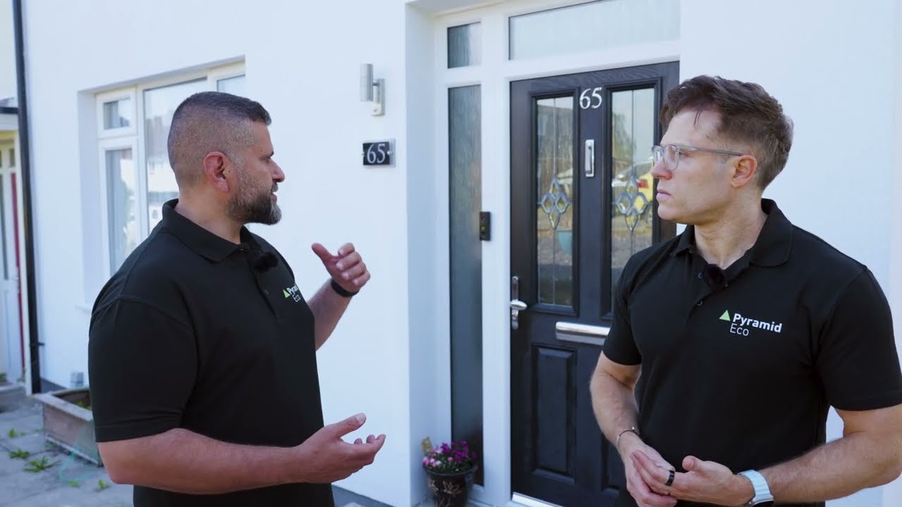 Tim Cameron-Kitchen and Michael Zohouri of Pyramid Eco looking at external wall insulation detailing at a South Oxhey property
