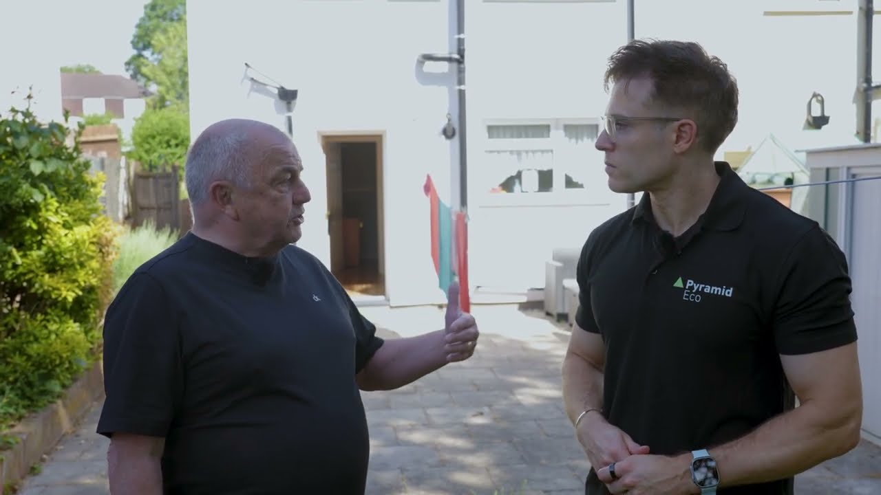 Homeowner Steve talking with Tim Cameron-Kitchen of Pyramid Eco outside his South Oxhey home after external wall insulation